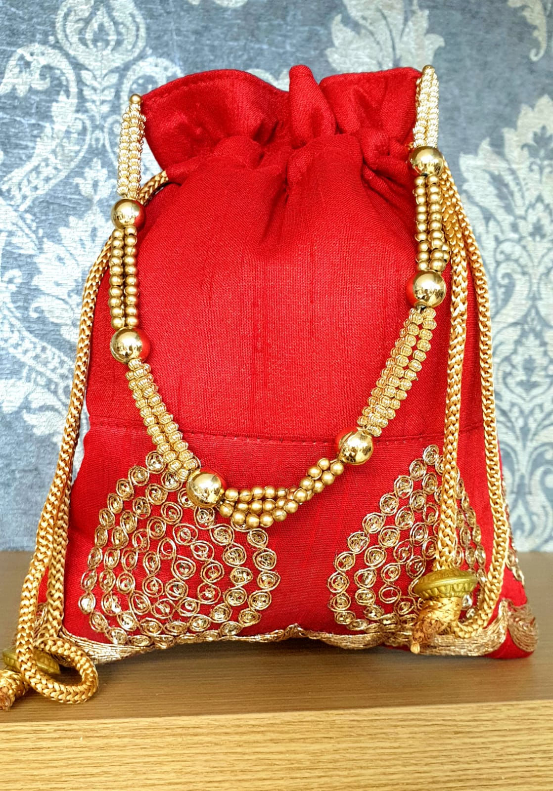 RED POUCH WITH GOLD DESIGN