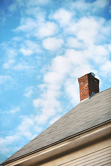 House roof with chimney and gutter, blue sky