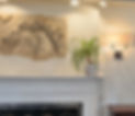Horse Frieze on a giant white and stone fireplace with sconces