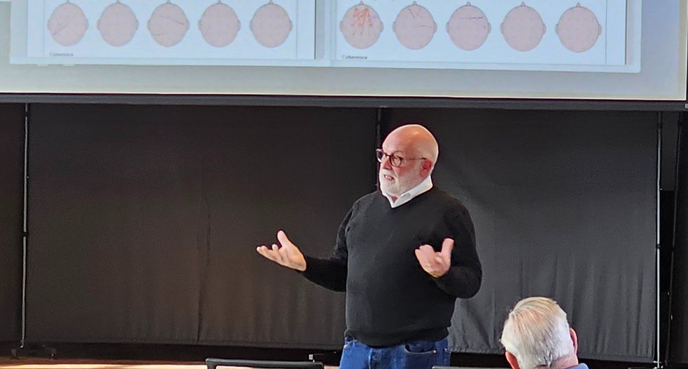 a MAN EXPLAINING THE PROJECTIONS OF BRAIN SCANS