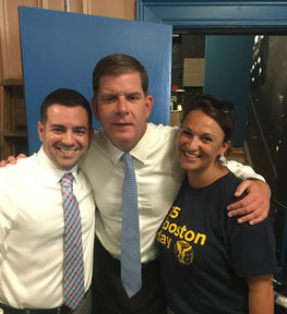 Martin J. Walsh, man, and woman in Boston Public Schools shirt