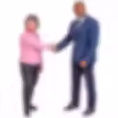 A woman is shown shaking hands with a man in a suit.