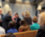 Congregation members greet pastor after service