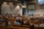 Pastor speaking to large congregation in church