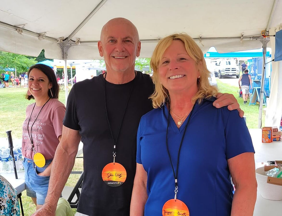 a man and woman standing next to each other under a tent