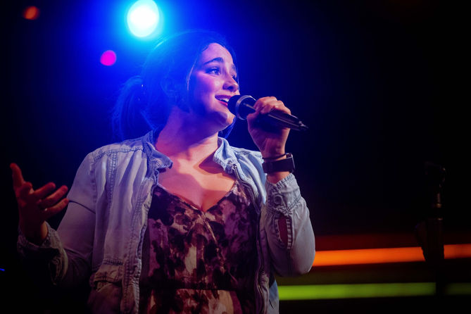 Singer Kristina V Wells performing on stage
