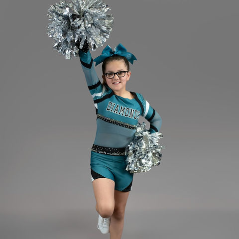 Kuna Diamonds Cheerleader wearing glasses and posing pom-poms
