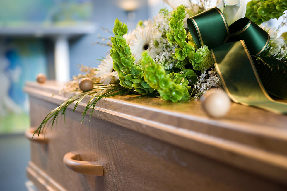 wood coffin with flowers on top