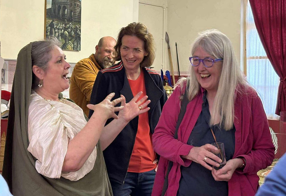 Pam Cox MP and Dame Mary Beard engaged in a lively conversation with re-enactor from Colchester Roman Society.