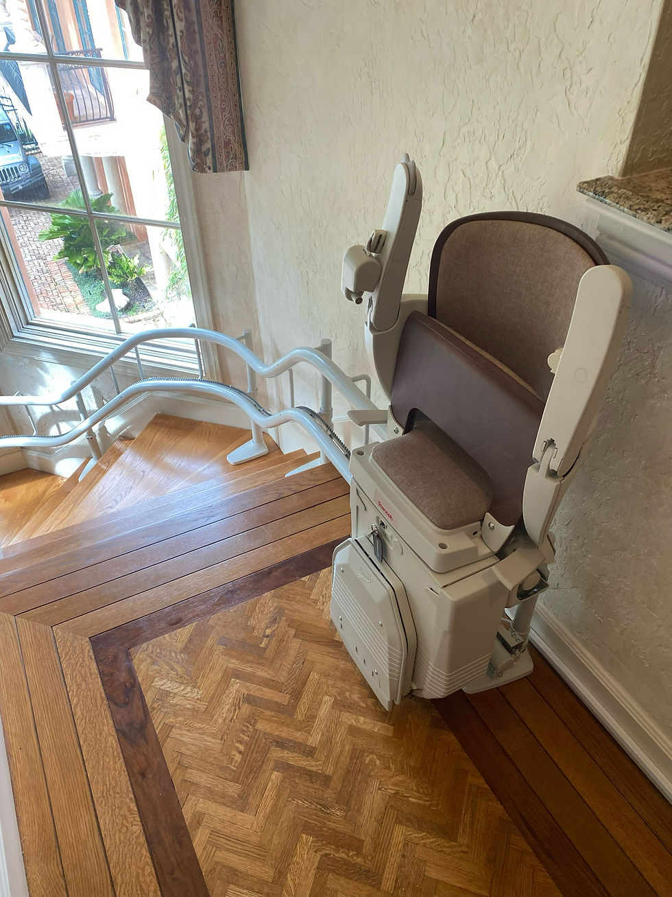 Wide angle view of a curved stairlift installed in a residential home