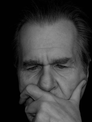 Man holding chin in a thinking pose