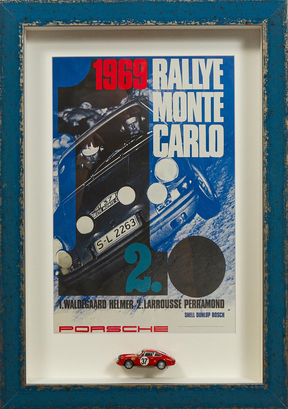 Framed Porsche 911 Rallye Monte Carlo Diorama with red 1:43 scale rally model and blue 1969 event poster in distressed blue f