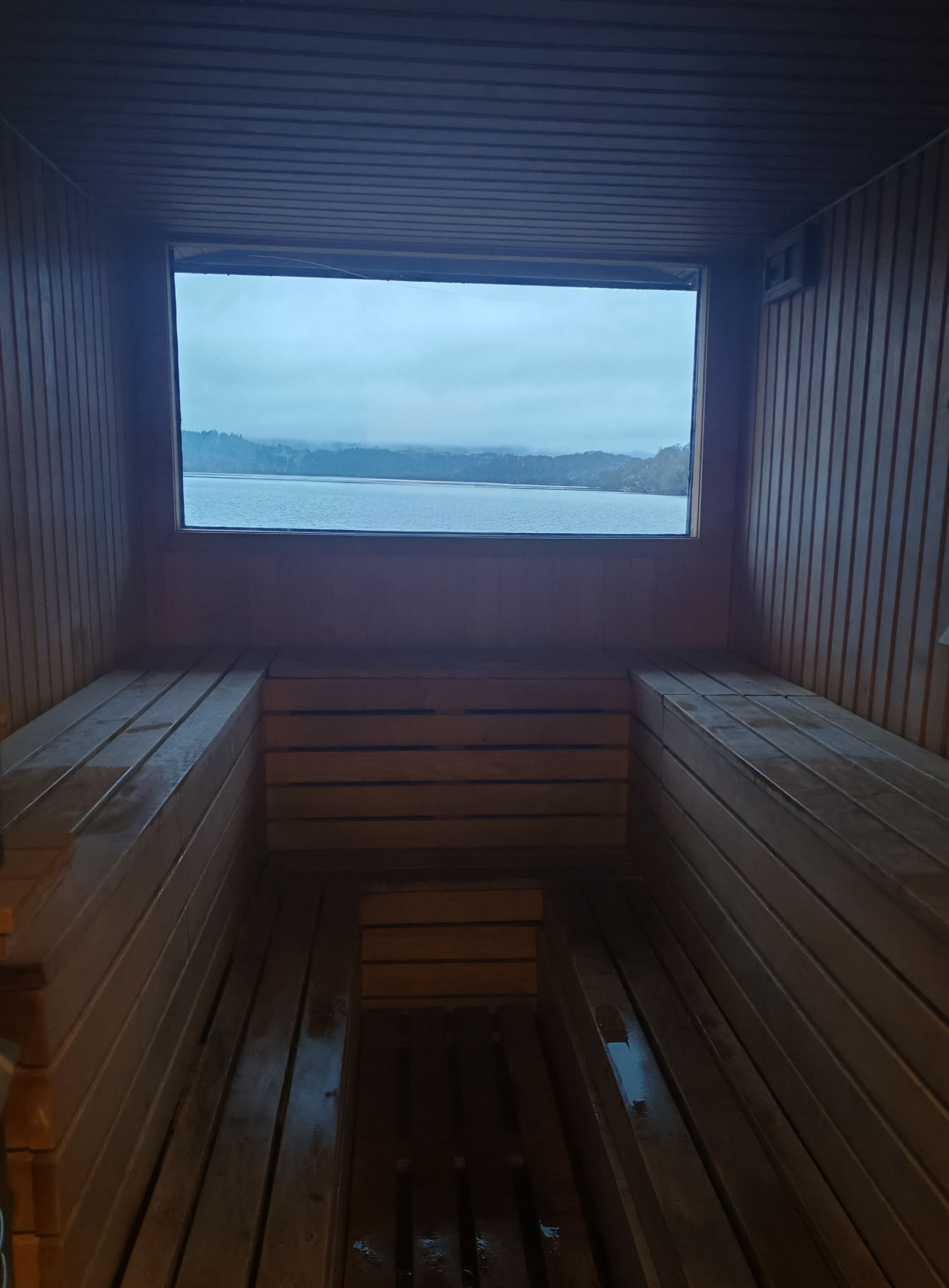View from inside sauna with wooden u-shaped seating