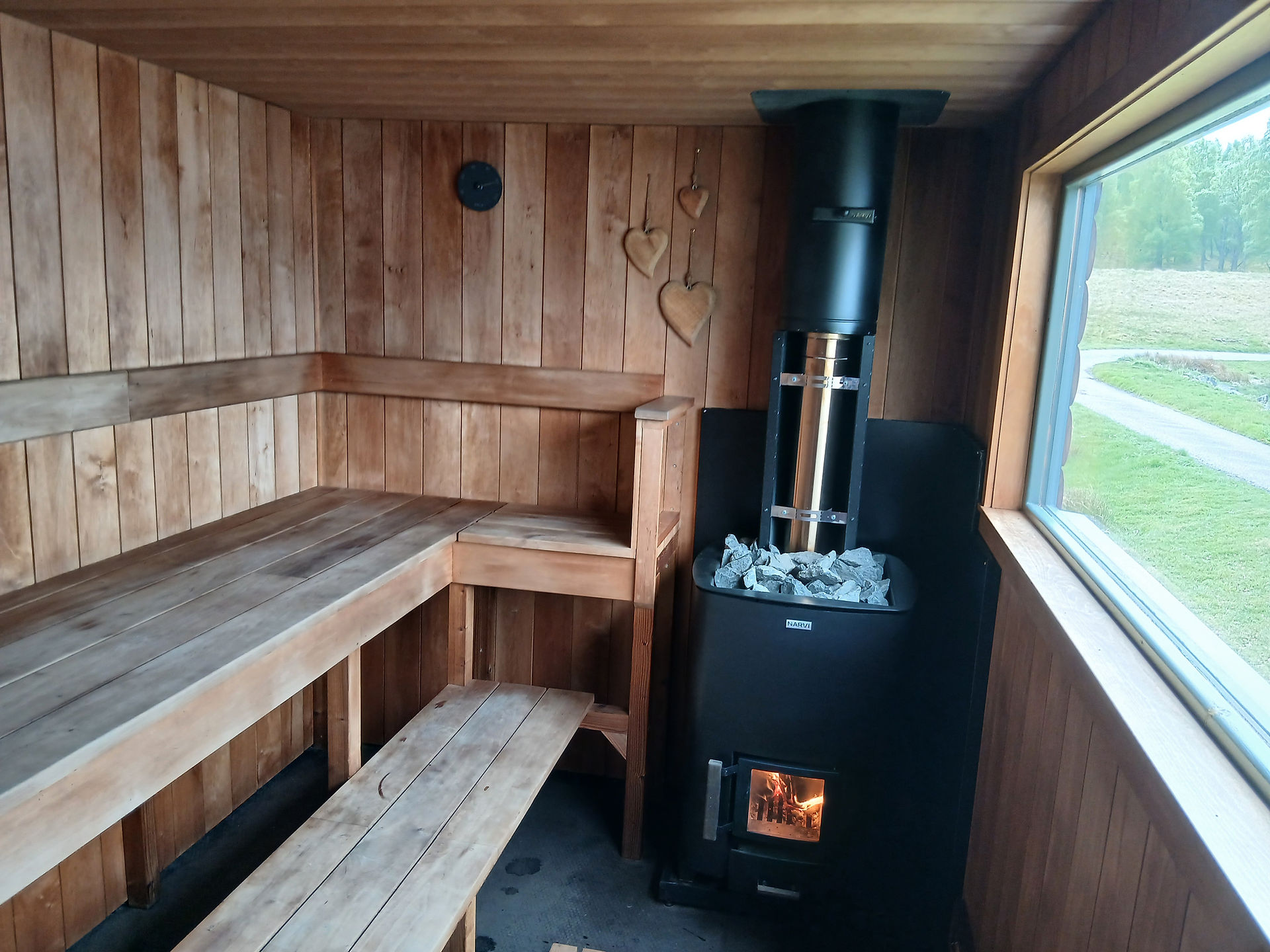 Wooden Sauna interior with stove in corner