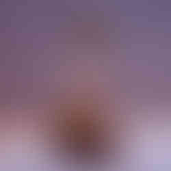 a fashionable young woman wearing a crop top and skirt, seemingly in a celebratory pose