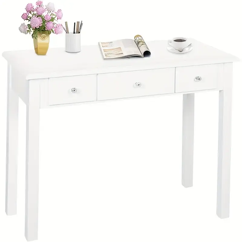 Minimalist white vanity desk with three drawers, styled with girly decor for a pink bedroom.
