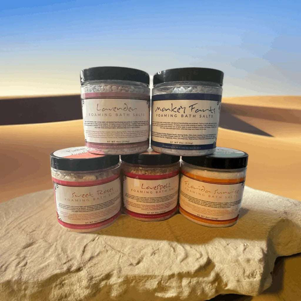 Rusty's Foaming Bath Salts sit on a smooth rock, ready to provide a luxurious and relaxing bath experience. The salts are packaged in a sleek and modern container, perfect for any bathroom decor. Add these bath salts to your routine for a spa-like experience in the comfort of your own home.