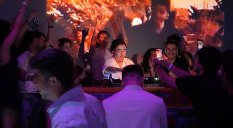 People are around the dj booth at brooklyn