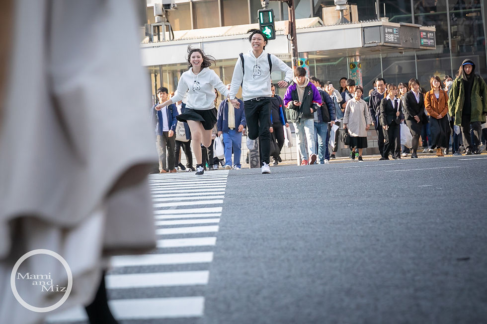 young couple running shibuya intersection