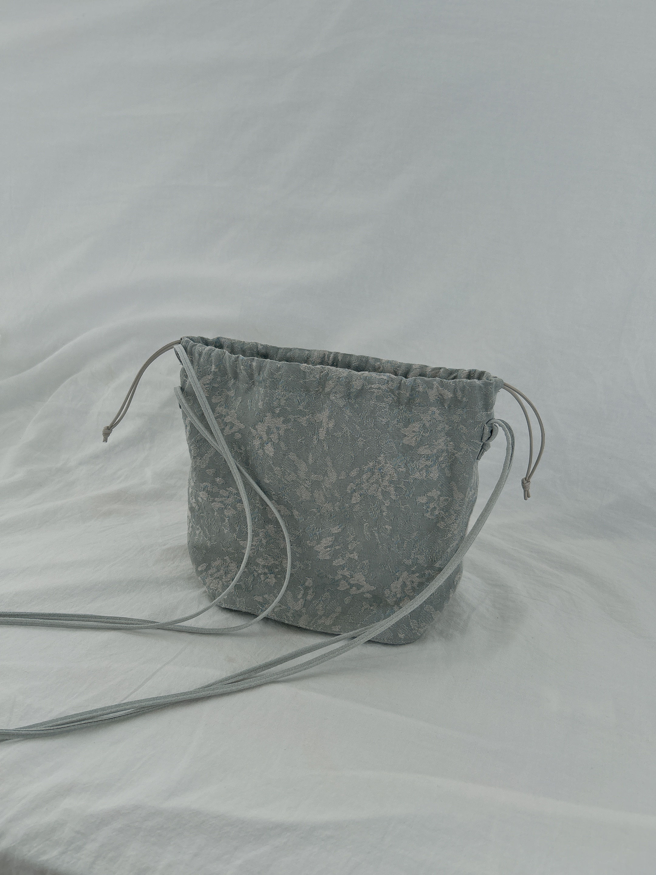 "refraction" jacquard drawstring bag
