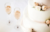 Wedding Cake And Champagne Flutes On Table