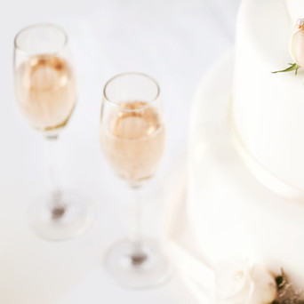 Wedding Cake And Champagne Flutes On Tab