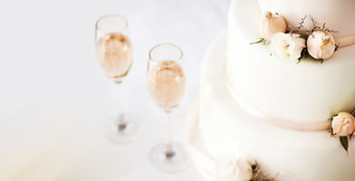 Wedding Cake And Champagne Flutes On Tab