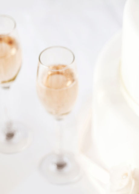 Wedding Cake And Champagne Flutes On Table
