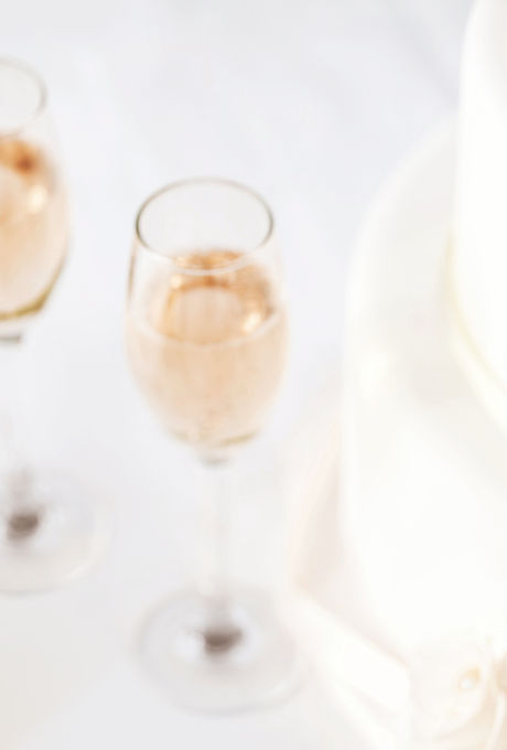 Wedding Cake And Champagne Flutes On Table