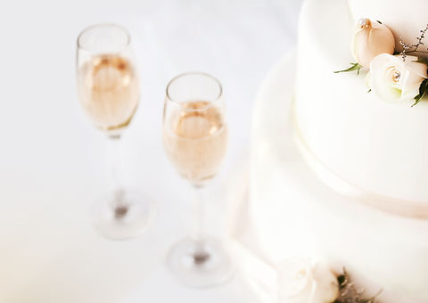Wedding Cake And Champagne Flutes On Table