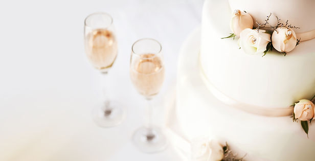 Wedding Cake And Champagne Flutes On Table