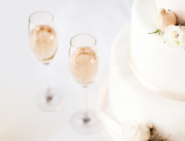 Wedding Cake And Champagne Flutes On Table