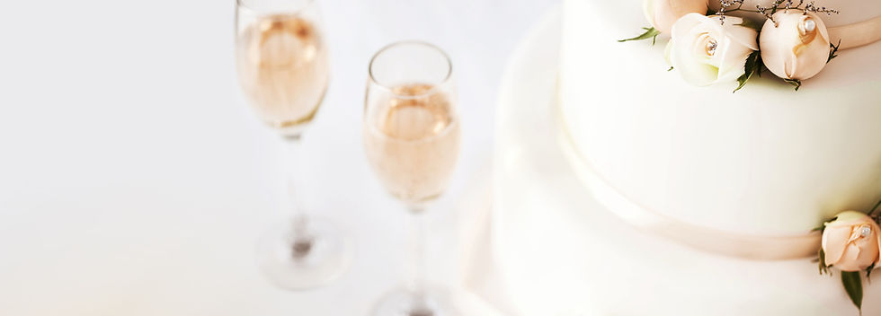 Wedding Cake And Champagne Flutes On Table