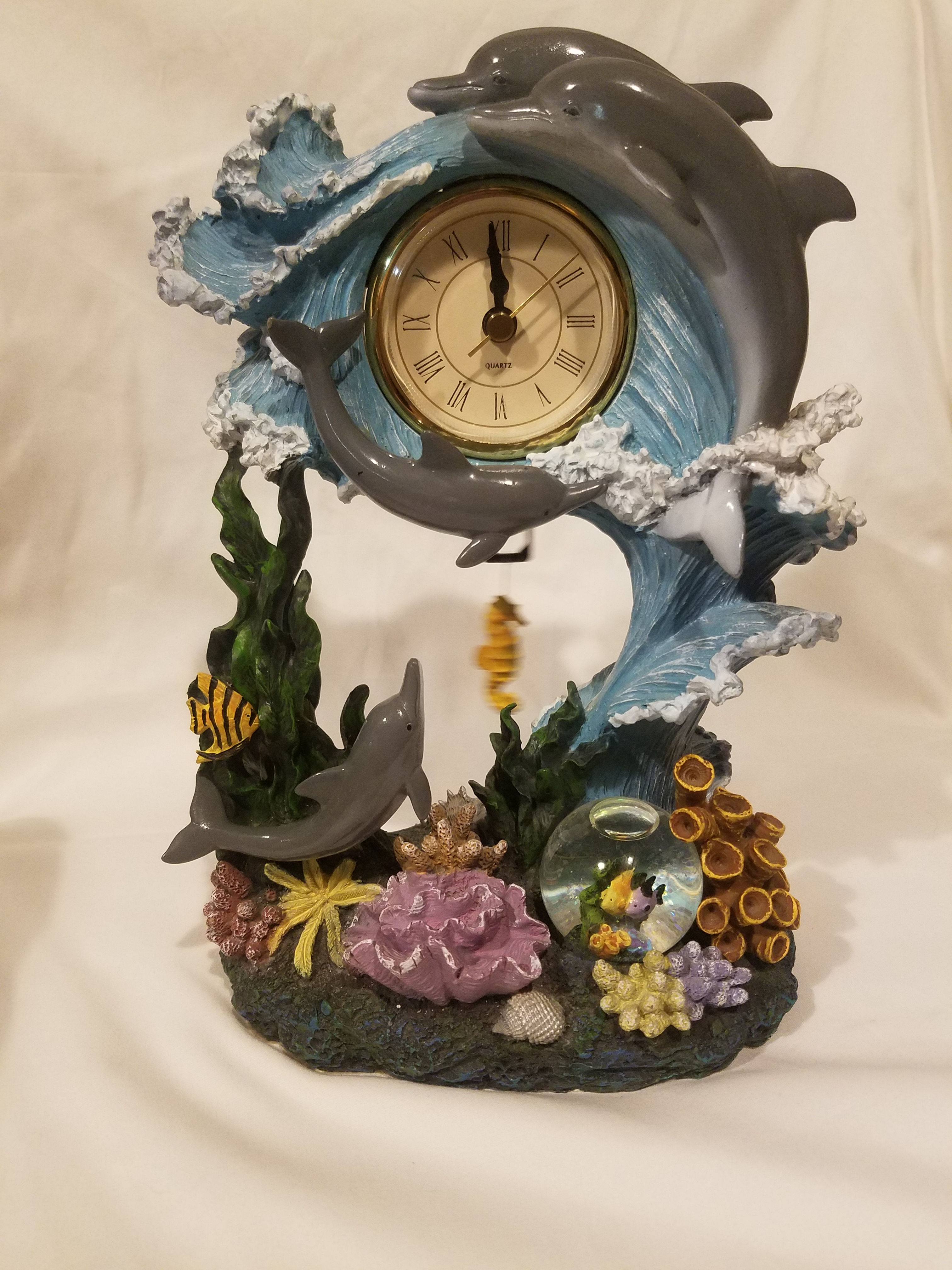 Ceramic dolphin clock with a water globe