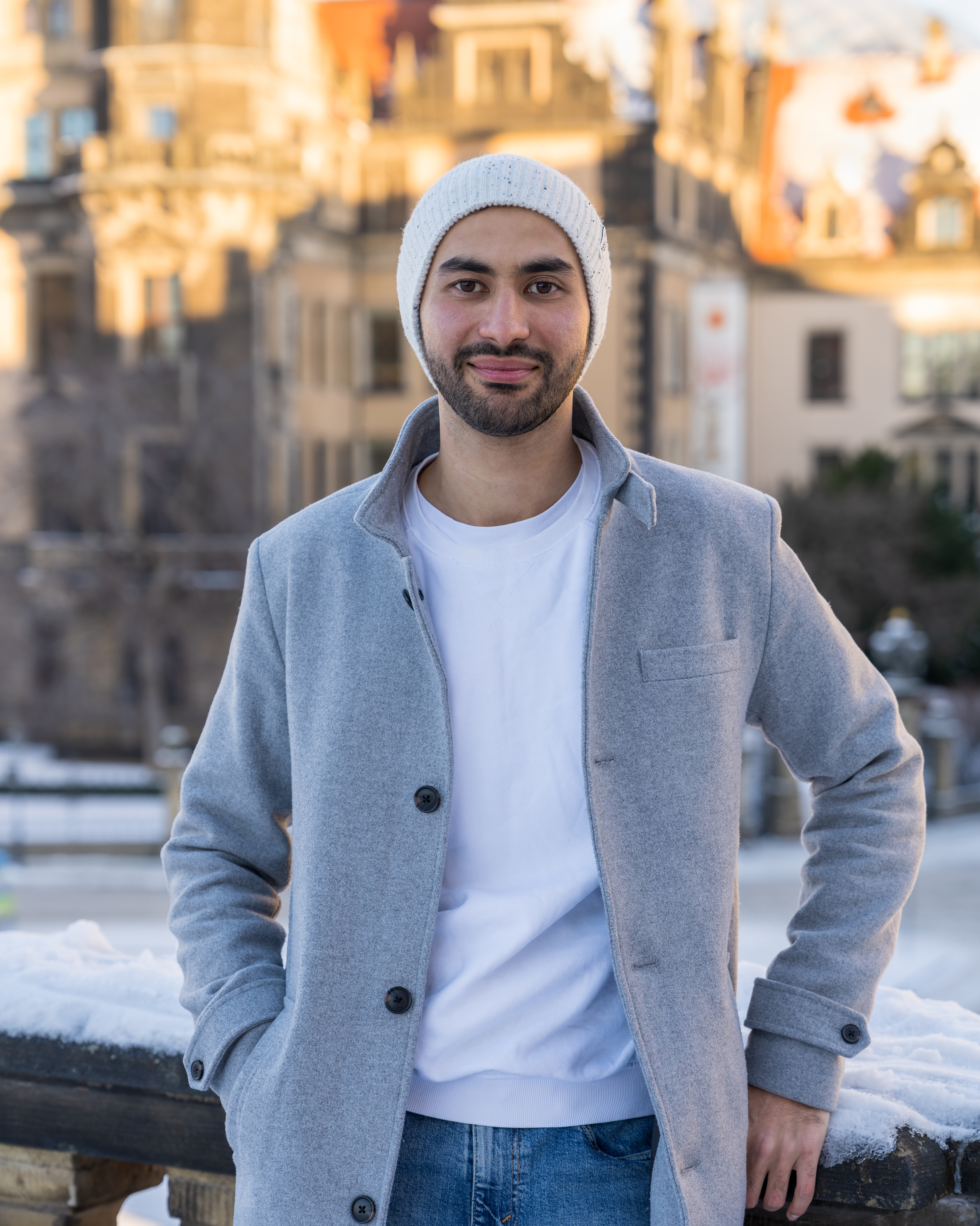 portrait-handsome-young-man-smiling-asian-man-with-neat-beard-stands-near-wall-looks-camer