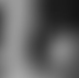 Black and white blurry engagement photography of couple holding hands outside of 106 Jefferson hotel in Huntsville, Alabama