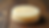Close-up view of creamy goat milk soap bar on rustic wooden surface