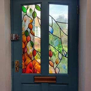 Colourful modern stained glass windows based on seasons in traditional domestic setting