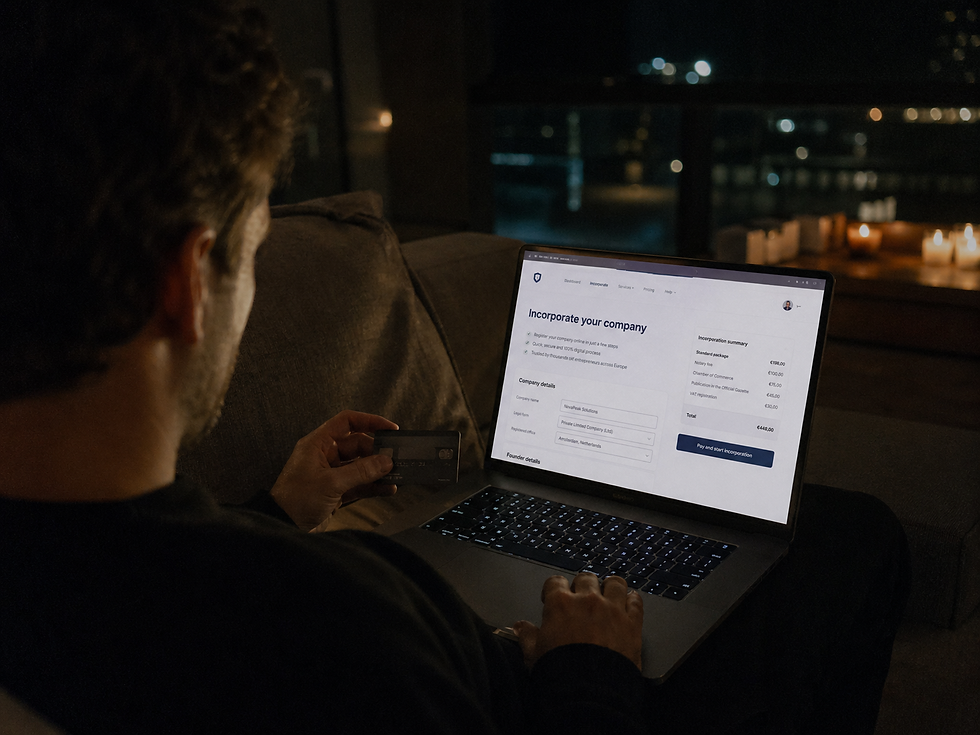 A documentary photograph from over the shoulder of a founder using a laptop and credit card at night, symbolizing fast digital business incorporation in Europe.