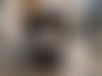 A candid documentary photograph of a newborn baby sleeping in a stroller on a traditional Portuguese cobblestone sidewalk, symbolizing birth and integration in Portugal.