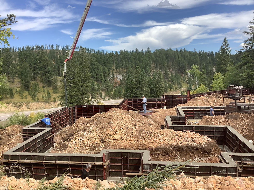 Construction workers pouring concrete for a building foundation