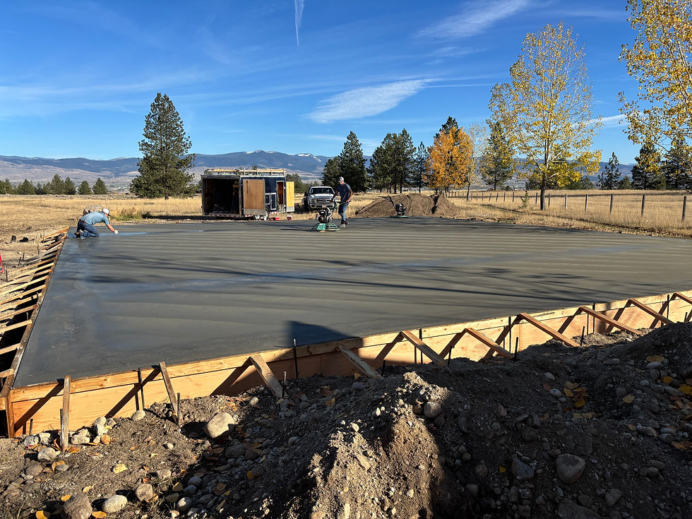 Freshly poured concrete slab with workers