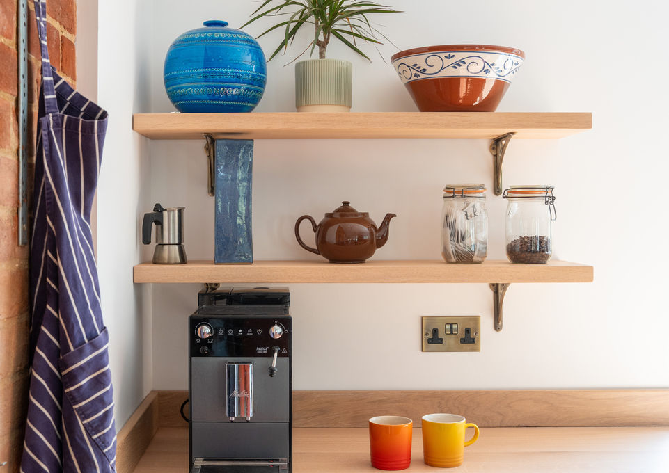 Bespoke, solid oak open shelves in a luxury, custom designed Shaker kitchen. Custom designed traditional English kitchen cabinets. Made by artisans in England sustainable oak hand made, high-end luxury modern kitchen furniture