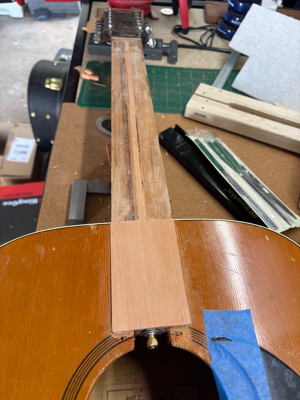 A mahogany patch goes into the end portion of the neck where there was some tear-out. Truss rod glued in...