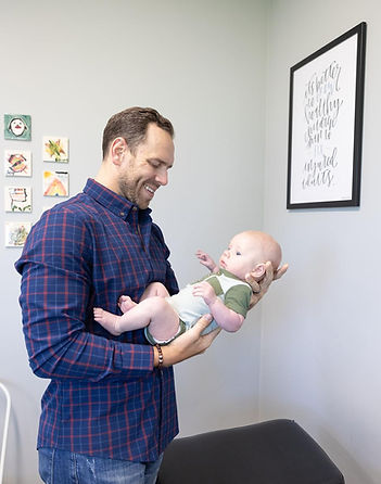 Gentle chiropractic adjustment to support a baby with reflux at Compass Chiropractic
