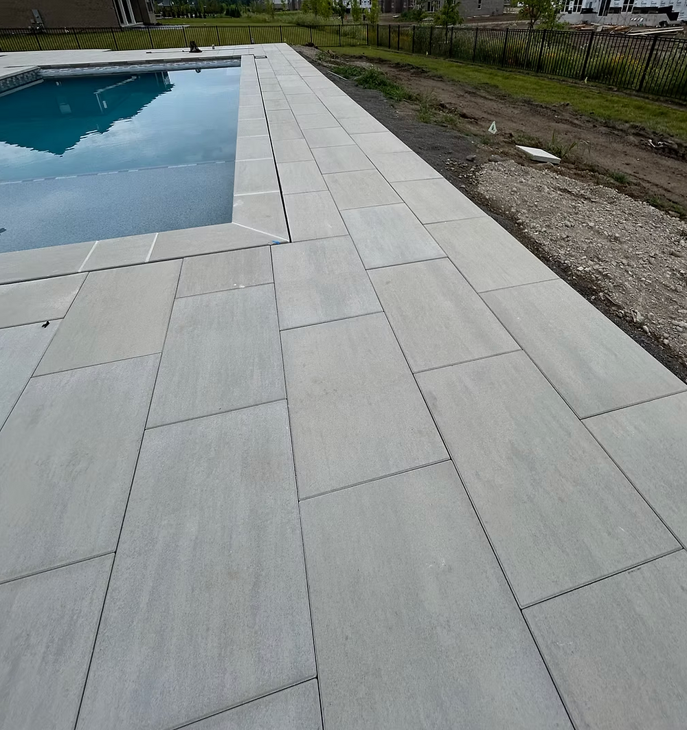 Poolside paver patio and landscaping installation in Plymouth MI