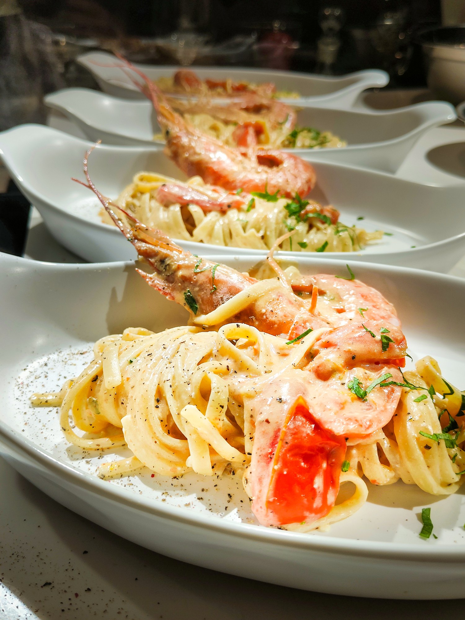 Linguine with prawns served down the chef's table at a Segreto corporate dinner party, Bangkok