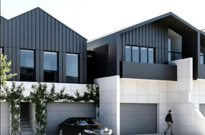 Contemporary townhouses in backyard of corner lot.