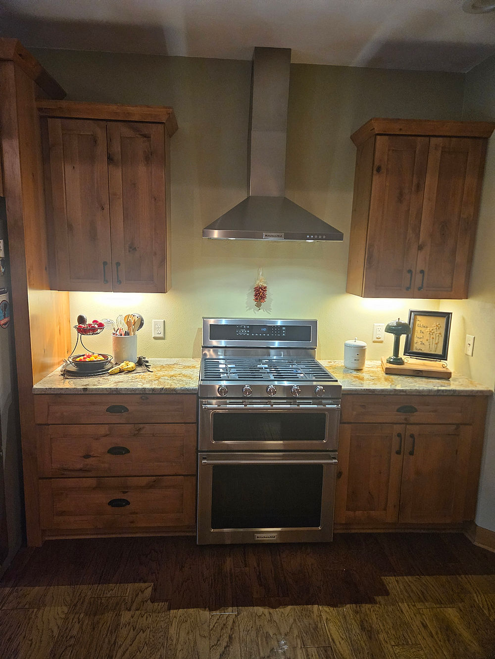 Wooden kitchen cabinets with stainless steel range in a design Portfolio
