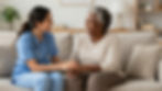 Nurse and senior woman smiling on a sofa